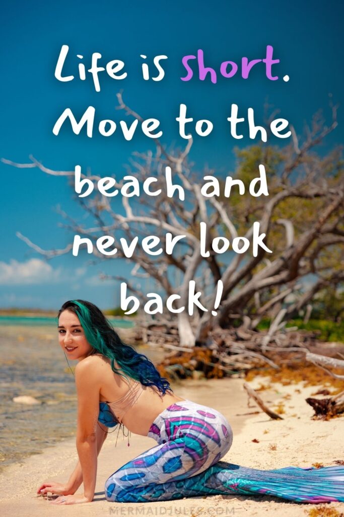 "Life is short. Move to the beach and never look back!" beach quote over a blue mermaid at a the shore line.