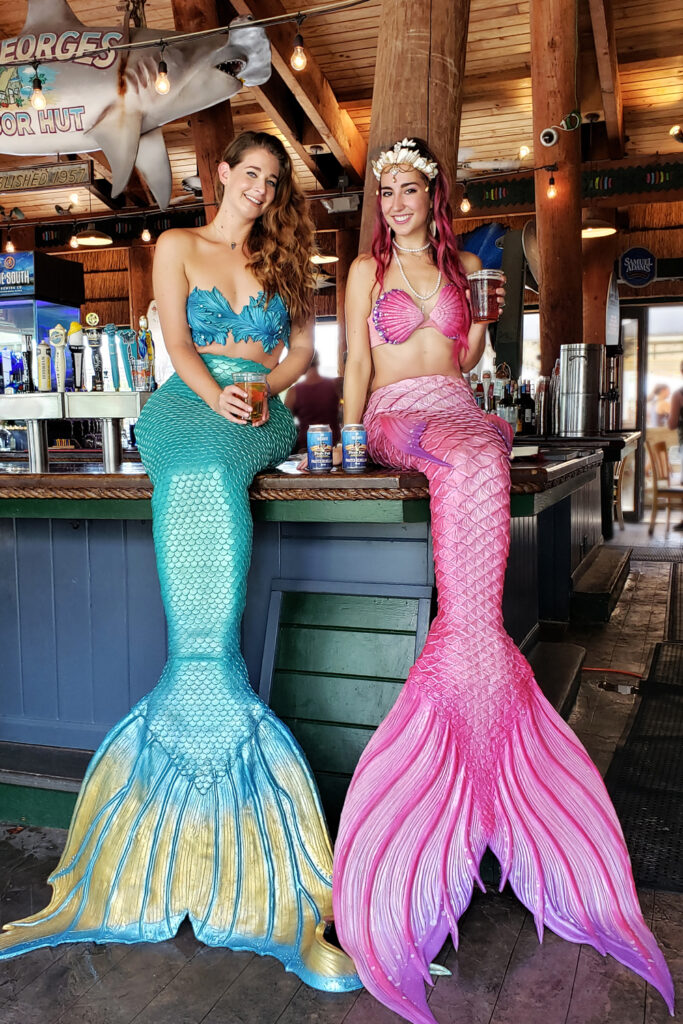 Mermaids on a bar, drinking beers in Boynton Beach Florida.