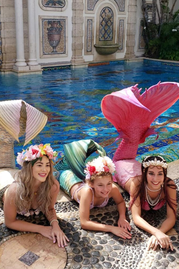 Mermaid Jules poses with Make a Wish patient at the Versace Mansion in Miami, Florida.