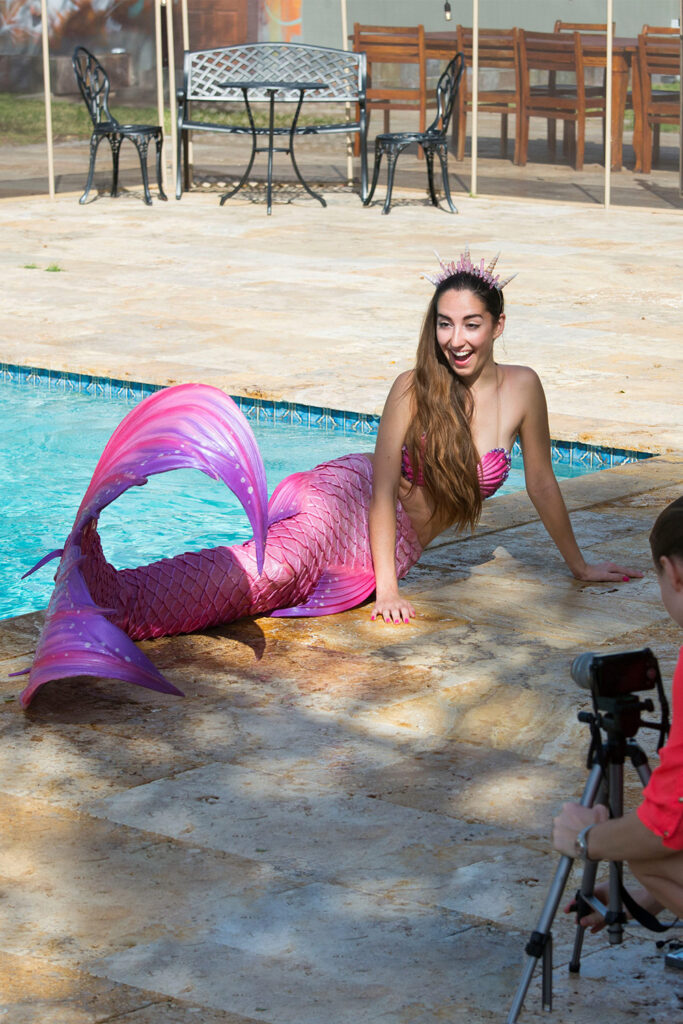 Mermaid Jules is interviewed poolside in her pink mermaid tail