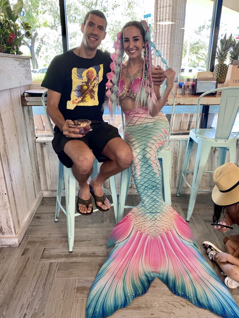 Mermaid Jules poses with guests at Playa Bowls Davie Grand opening.