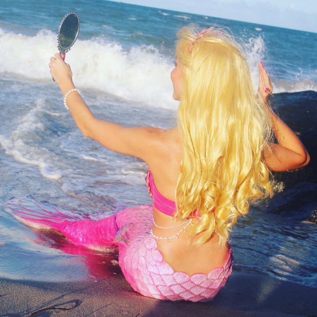Mermaid Jules cosplaying as Barbie in her hot pink mermaid tail.