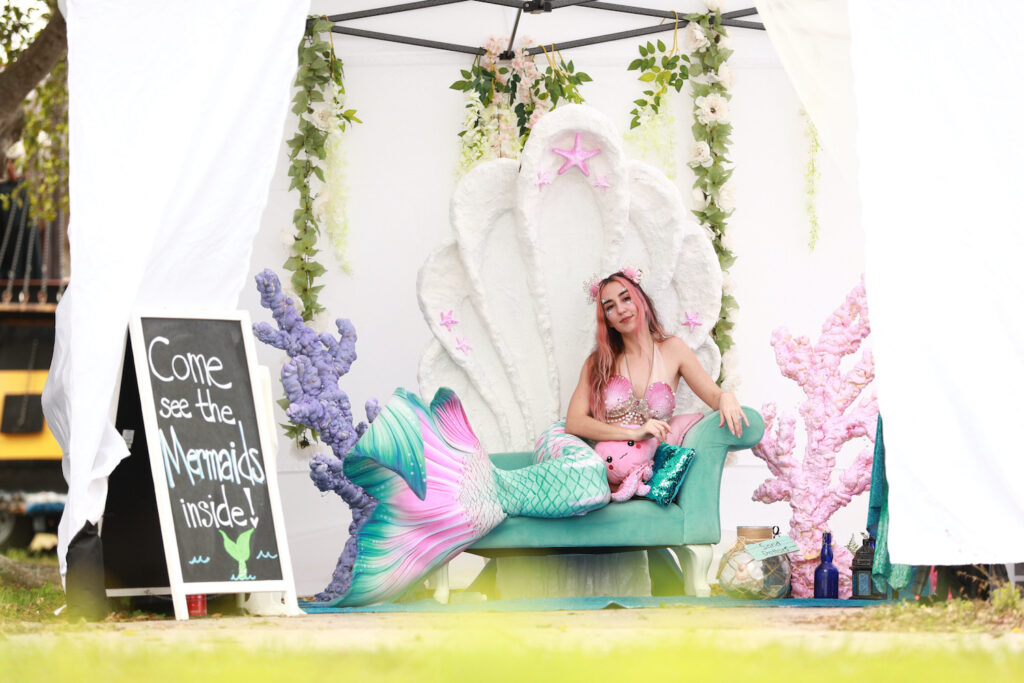 Mermaid Jules poses in her grotto at the 2022 Treasure Coast Pirate Festival