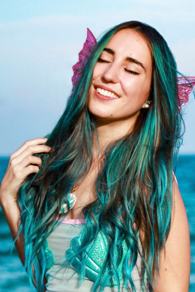Mermaid with aquamarine hair smiling