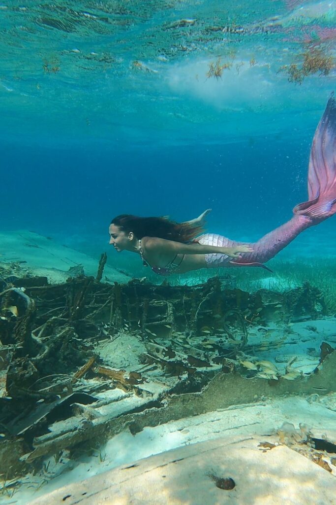Mermaid swims sunken plane wreck - Bahamas Boat Tour destination