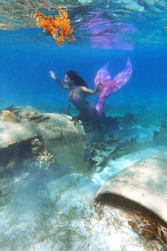 Mermaid explores pablo escobars sunken plane wreck - bahamas boat tour
