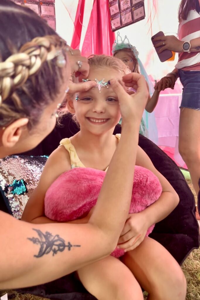 getting mermaid face gems at Boynton Beach pirate fest