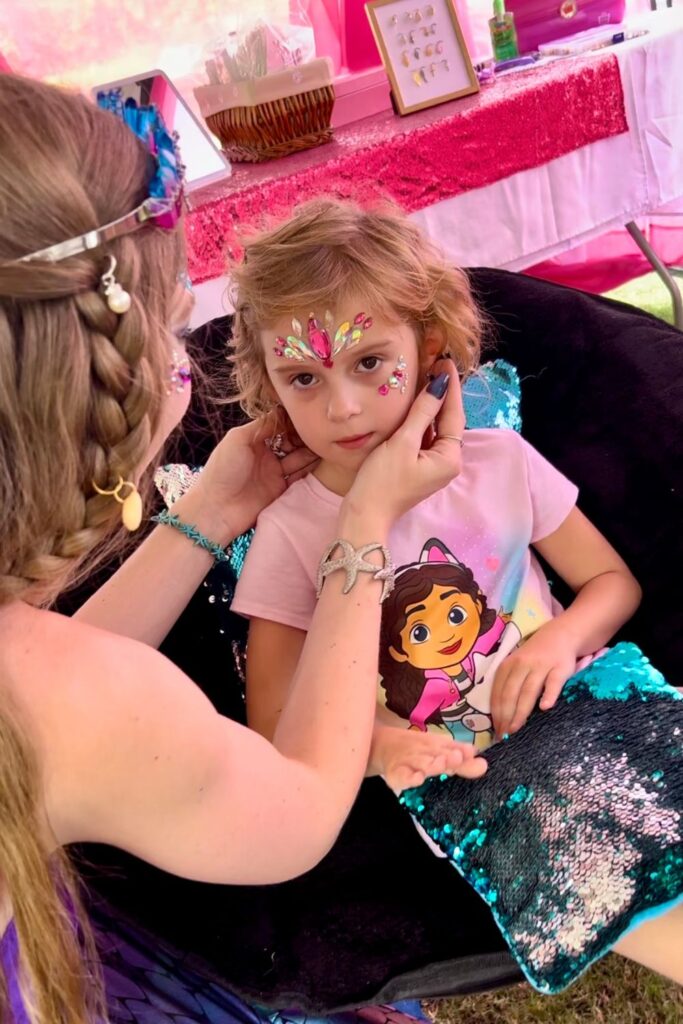 getting mermaid face gems at Boynton Beach pirate fest