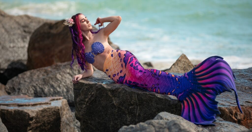 Mermaid Jules models Finfolk's gorgeous pink & purple "All Hallows Eve" mermaid tail.